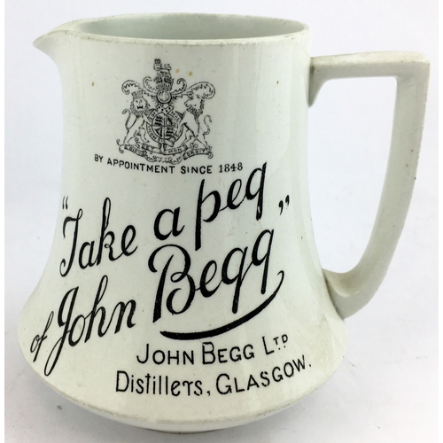 90 - JOHN BEGG LTD DISTILLERS GLASGOW WHISKY WATER JUG. 5.1ins tall. Black design both sides - coat of ar... 