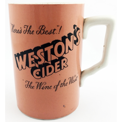 97 - WESTONâS CIDER JUG. 5.25ins tall. Black transfer on dark peach body, handled. HEREâS THE BEST/ T... 