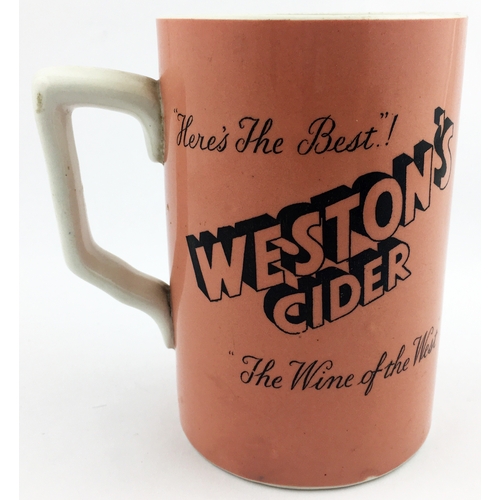 97 - WESTONâS CIDER JUG. 5.25ins tall. Black transfer on dark peach body, handled. HEREâS THE BEST/ T... 