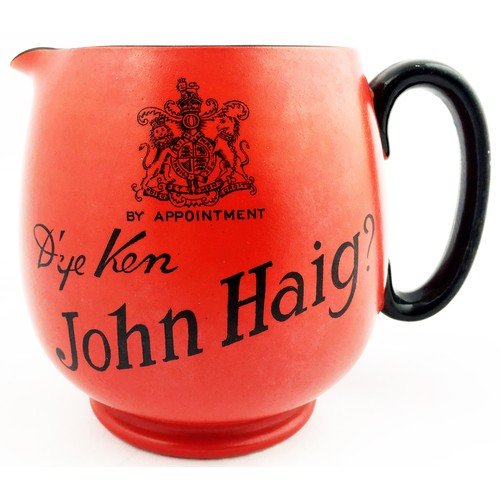 180 - DYE KEN JOHN HAIG WATER JUG. 4.5 ins tall. Deep red body, black transferred coat of arms each side p... 