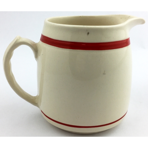 195 - OLD BUSHMILLS WATER JUG. 4ins tall. Red line below lip, black & yellow side design featuring rising ... 