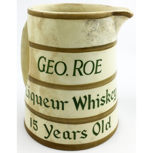 196 - GEO ROE LIQUEUR WHISKEY WATER JUG. 5 ins. tall. Tapering cylinder, green letters each side, five lig... 