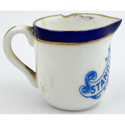 130 - SINGLE MEASURE CREAM JUG. 1.5ins tall. Blue lip, blue transfer, rear handle. STANDINGâS CAFE. Gold... 