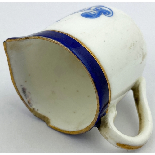 130 - SINGLE MEASURE CREAM JUG. 1.5ins tall. Blue lip, blue transfer, rear handle. STANDINGâS CAFE. Gold... 