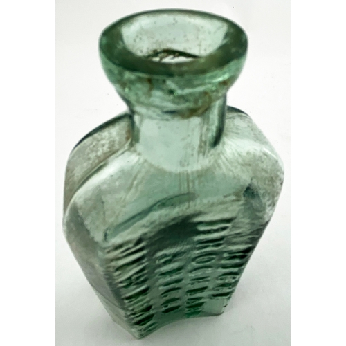 29 - RIGGE EMBOSSED EARLY MEDICINE BOTTLE. 6ins tall, aqua glass, tooled band lip, arched shoulders with ... 