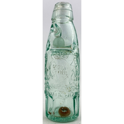 329 - KEYSTONE CODD BOTTLE. 7.5ins tall. Aqua glass, 10 sided base, 2 neck retaining lugs. Heavily embosse... 