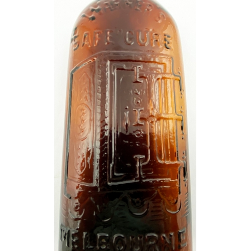 37 - WARNERS SAFE CURE MELBOURNE BOTTLE. 9.5ins tall. One pint, red amber glass, sloping shoulders, short... 