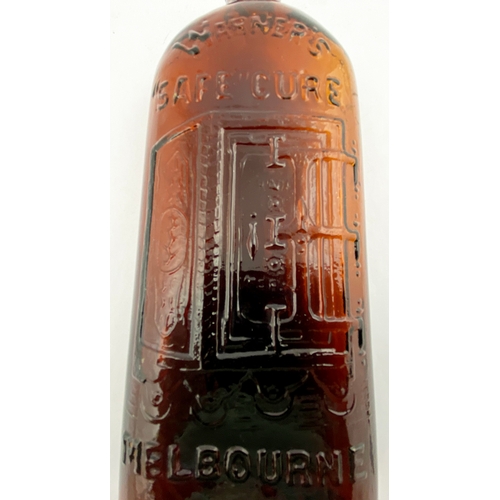 40 - WARNERS SAFE CURE MELBOURNE BOTTLE. 9.25ins tall. One pint, red amber glass, sloping shoulders, sh... 