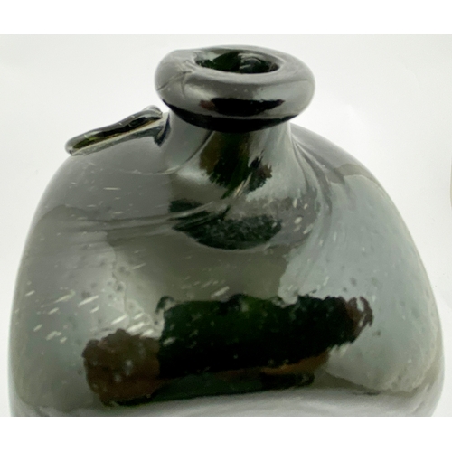 63 - SEALED CASE GIN BOTTLE. 11ins tall. Dark olive green glass, pig snout lip. Seal with AVH embossed to... 