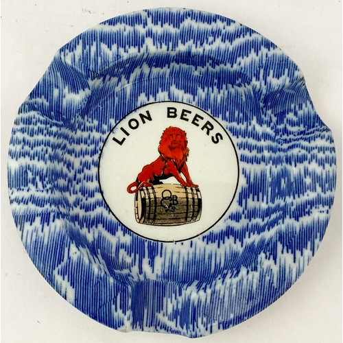 22 - LION BEERS ASHTRAY. 4.75ins diam. Red enamelled lion to centre, faded gold band to outer edge. Shaw/... 