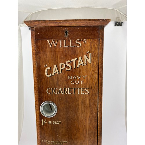 24 - WILLS CAPSTAN NAVY CUT CIGARETTE MACHINE. 23ins tall, 7ins wide, 8.25ins length. Wooden machine with... 