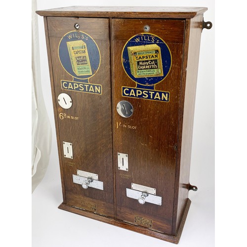 29 - WILLS CAPSTAN DUAL CIGARETTE MACHINE. 23ins tall, 7ins wide, 15ins length. Wooden machine with hinge... 