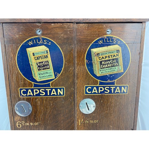 29 - WILLS CAPSTAN DUAL CIGARETTE MACHINE. 23ins tall, 7ins wide, 15ins length. Wooden machine with hinge... 