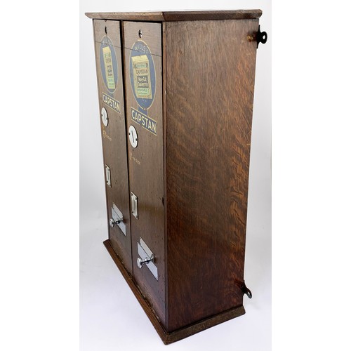 29 - WILLS CAPSTAN DUAL CIGARETTE MACHINE. 23ins tall, 7ins wide, 15ins length. Wooden machine with hinge... 