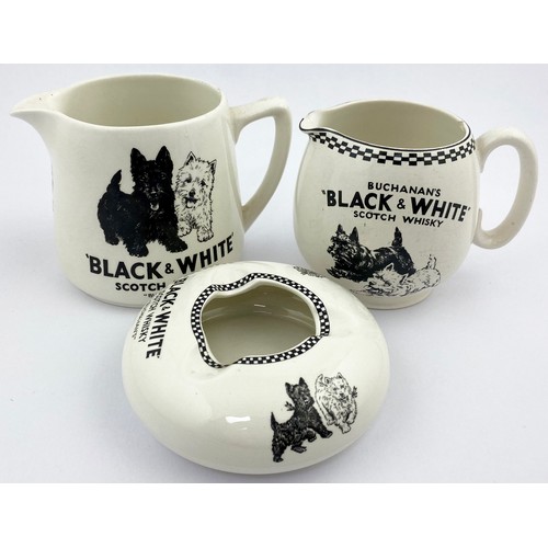 87 - BUCHANANS BLACK & WHITE TRIO. Tallest 4ins. Two jugs with dogs pict one with coat of arms plus ashtr... 