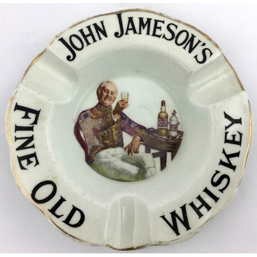 114 - JOHN JAMESONS WHISKEY ADVERTISING ASHTRAY.  4.75ins diam. Pict of man raising glass to centre, outer... 