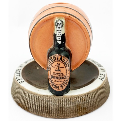 132 - WHITBREADS BOTTLED BEERS MATCHSTRIKER ASHTRAY. 5ins diam. Side laying peach coloured barrel, support... 