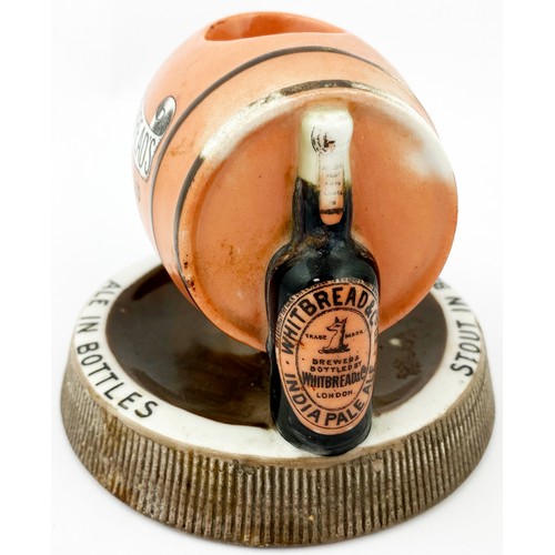 132 - WHITBREADS BOTTLED BEERS MATCHSTRIKER ASHTRAY. 5ins diam. Side laying peach coloured barrel, support... 