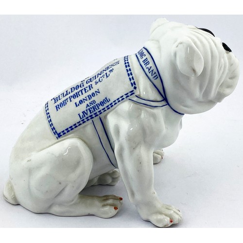 307 - BULLDOG GUINNESS FIGURE. 7ins tall. All white characterful seated bulldog some black patches, blue l... 