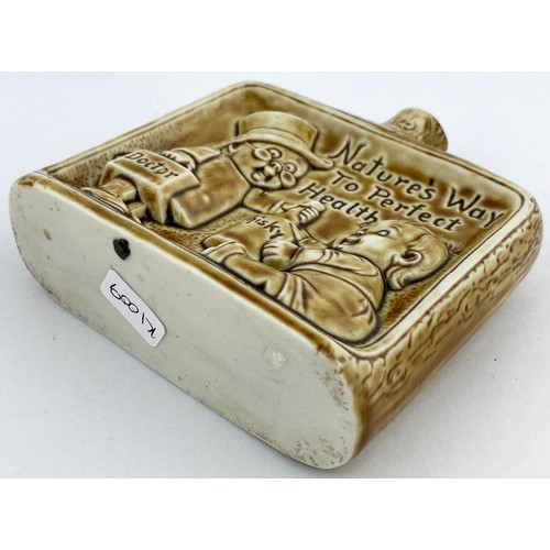 312 - IRISH SPIRIT HIP FLASK. 4.25ins. Raised images of Doctor & baby with Whisky bottle with impressed le... 