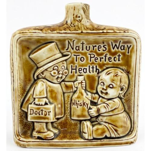 312 - IRISH SPIRIT HIP FLASK. 4.25ins. Raised images of Doctor & baby with Whisky bottle with impressed le... 