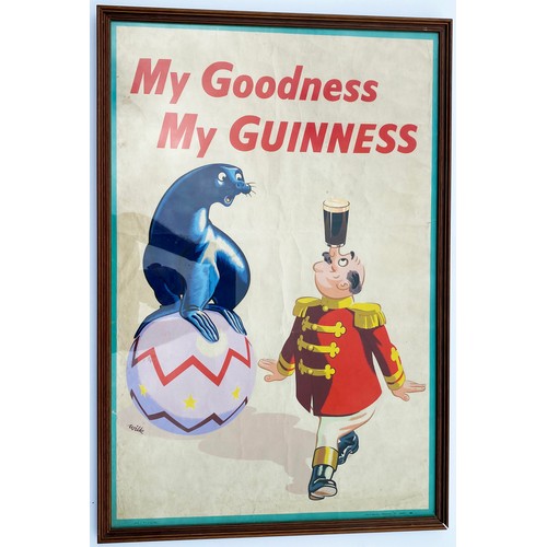 314 - GUINNESS FRAMED POSTER. 21 x 31ins. Original colourful poster of seal on ball & man balancing pint o... 