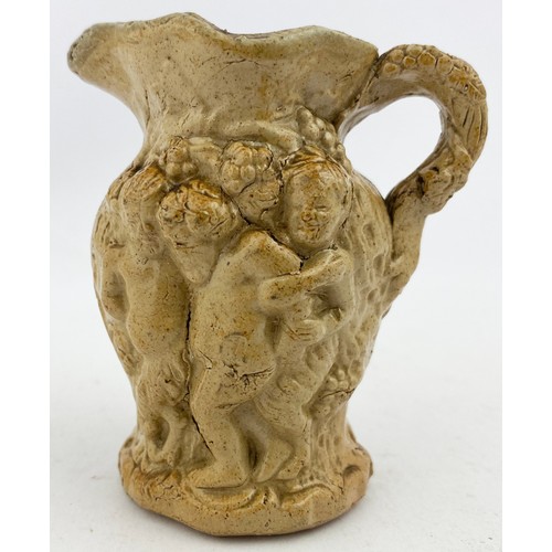 33 - SILENUS & BACCHUS RELIEF MOULDED JUG. 3.3ins tall. Mid brown salt glaze jug, rear handle, flared foo... 