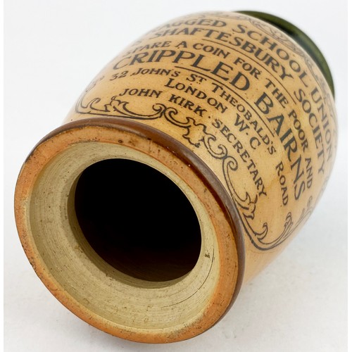 45 - RAGGED SCHOOL UNION MONEY BOX. 4.2ins. Stoneware salt glaze money box with dark green top. Front tra... 