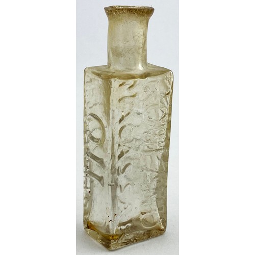 216 - ROWLANDS MACASSAR OIL BOTTLE. 3.8ins tall. Clear flint glass, flattened rectangular body, short neck... 