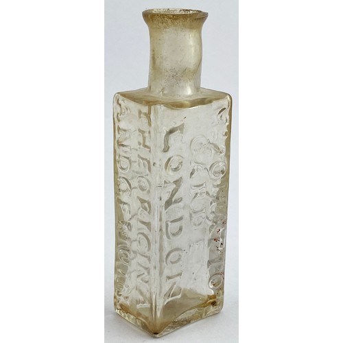 216 - ROWLANDS MACASSAR OIL BOTTLE. 3.8ins tall. Clear flint glass, flattened rectangular body, short neck... 