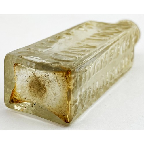 216 - ROWLANDS MACASSAR OIL BOTTLE. 3.8ins tall. Clear flint glass, flattened rectangular body, short neck... 