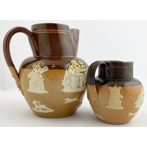 335 - DOULTON LAMBETH JUG DUO. Tallest 5.25ins.T.t., both sprigged, rear handles, one with black transfer ... 