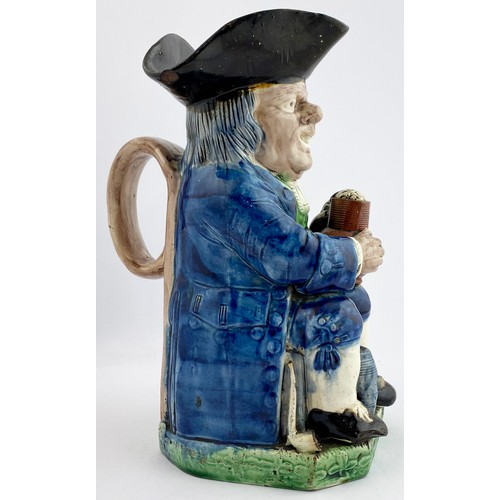 339 - STAFFORDSHIRE TOBY JUG. 10ins tall. Blue & green glaze figure of seated man with a beer. In manufact... 