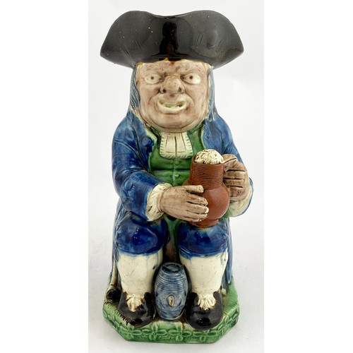 339 - STAFFORDSHIRE TOBY JUG. 10ins tall. Blue & green glaze figure of seated man with a beer. In manufact... 