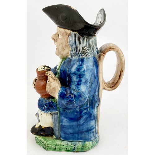 339 - STAFFORDSHIRE TOBY JUG. 10ins tall. Blue & green glaze figure of seated man with a beer. In manufact... 