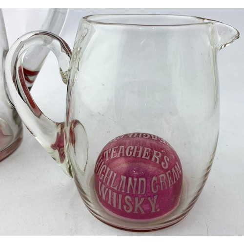 99 - USHERS & TEACHERS CRANBERRY BASED WATER JUGS DUO. Tallest 8ins. Clear glass, side handles, both with... 