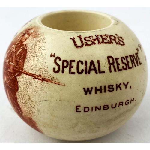 100 - USHERS OVG WHISKY MATCHHOLDER. 2.5ins tall. Spherical body with flat top. Dark brown/ red transfer a... 