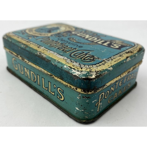 327 - GUNDILLS GENUINE PONTEFRACT CAKES. 2.9 x 4.1 x 1.2ins. Generally good condition, some surface & edge... 