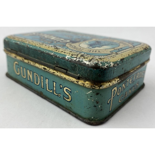 327 - GUNDILLS GENUINE PONTEFRACT CAKES. 2.9 x 4.1 x 1.2ins. Generally good condition, some surface & edge... 