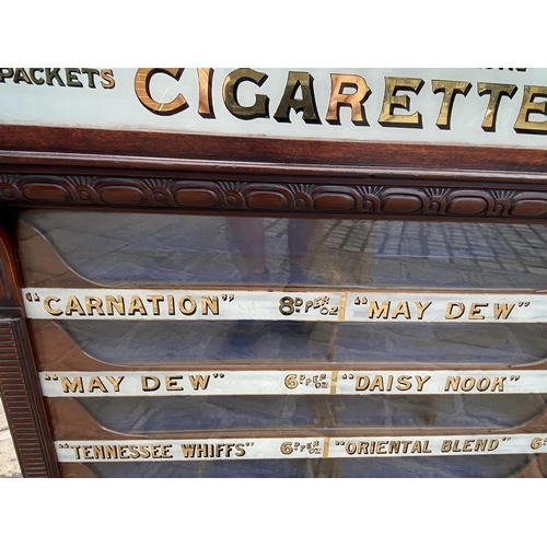 340 - MITCHELLS CIGARETTES SHOP VENDING CABINET. 36 x 27 x 6ins. A highly decorative narrow bodied , glass... 