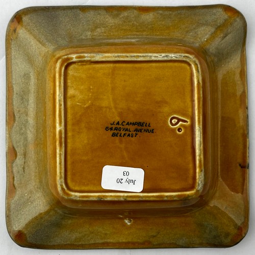 103 - BELFAST ASHTRAY. 4.5 x 4.5ins. Burnt amber gradating to very dark at rim with lettering round edge p... 