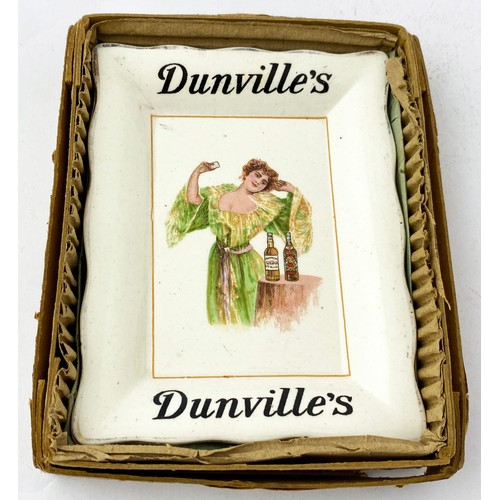 104 - DUNVILLES WHISKY ASHTRAY. 3.75 x 4.75ins. Off white with multi coloured detailed image of lady to ce... 