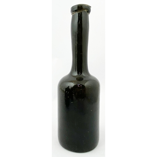 216 - HALF SIZE LADIES LEG WINE BOTTLE. 9.2ins tall. a true dense black glass (hint of green espied via th... 