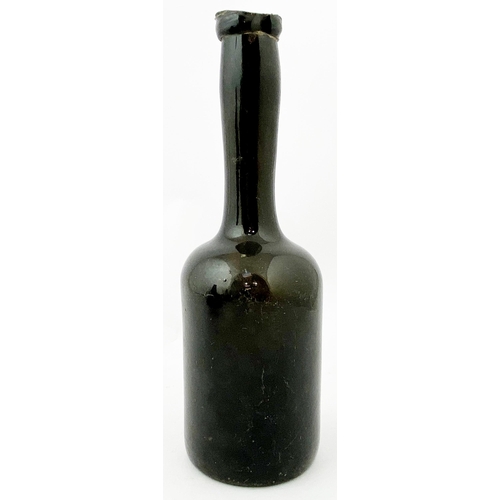 216 - HALF SIZE LADIES LEG WINE BOTTLE. 9.2ins tall. a true dense black glass (hint of green espied via th... 