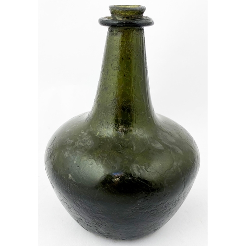 217 - ENGLISH SMALL SIZE SHAFT & GLOBE WINE BOTTLE. 6.4ins tall, dark green/ black glass, overall characte... 