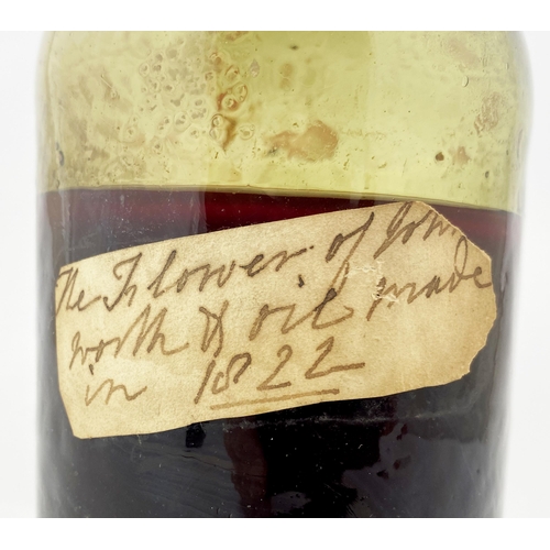 176 - FREEBLOWN LABELLED PHARMACY BOTTLE. 8ins to top of cork (original?). Dark green glass. Double collar... 