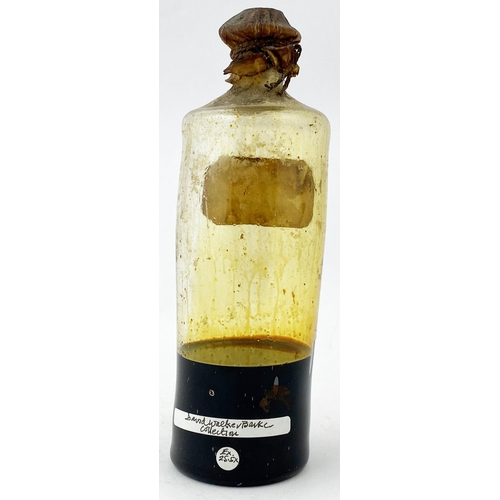 177 - FREEBLOWN LABELLED PHARMACY BOTTLE. 6.4ins tall. Thin lead glass tinged with the thick treacle like ... 