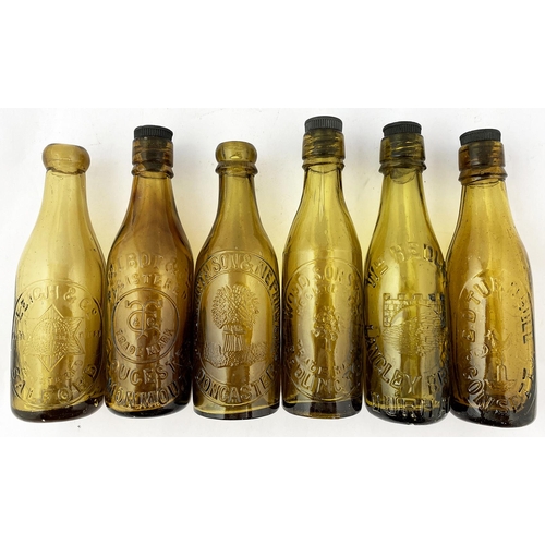 307 - PICTORIAL BEERS GROUP. Tallest 8.5ins. Light amber embossed, some with stoppers:. Bedlington, Doncas... 