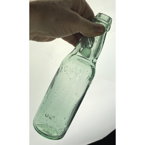 571 - LONDON BARRETT CODD BOTTLE. 9ins tall. Faint embossing to back & front. Lip nibbles & surface scratc... 