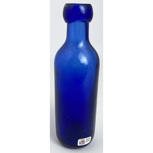 574 - NEWCASTLE BOTTLE. 6.5ins. Cobalt blue, faint embossing, R. EMMERSON , penny farthing pict t.m. Surfa... 